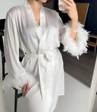 Robe made of satin with feathers on the sleeves