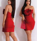 A short dress made of Lycra without shoulder straps and with a rose shape at the chest