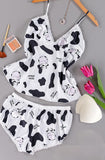 Two-piece pajamas made of satin with a cows print and lace around the edges