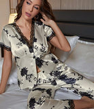 Two-piece pajama - made of floral satin - with lace around the neck, sleeves, and the end of the pants