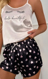 Two-piece satin pajamas - with hearts print on the shorts and eyelashes print on the top - Dala3ny